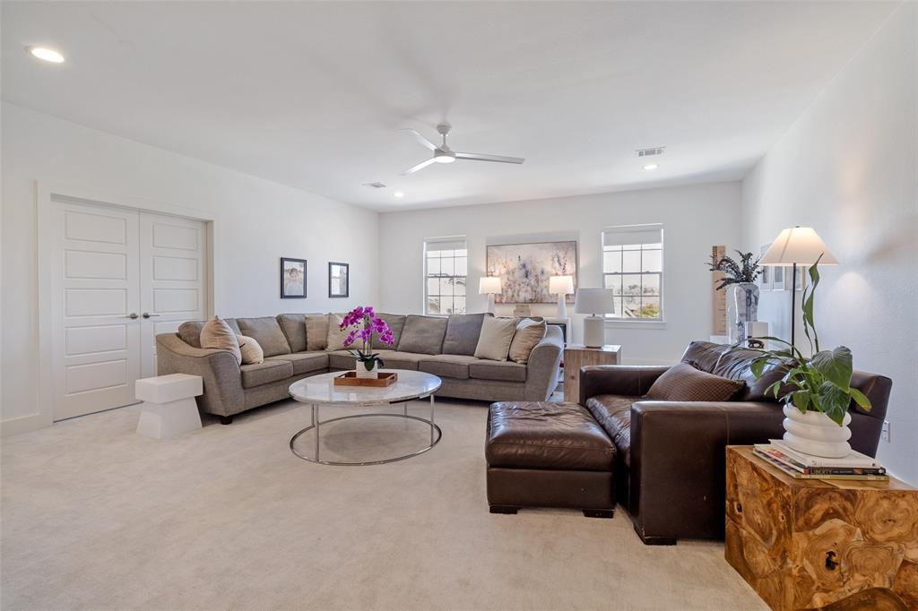 7533 Garonne Street Dallas, TX 75231 - Photo 17 of 32 a living room with furniture a chandelier and a window