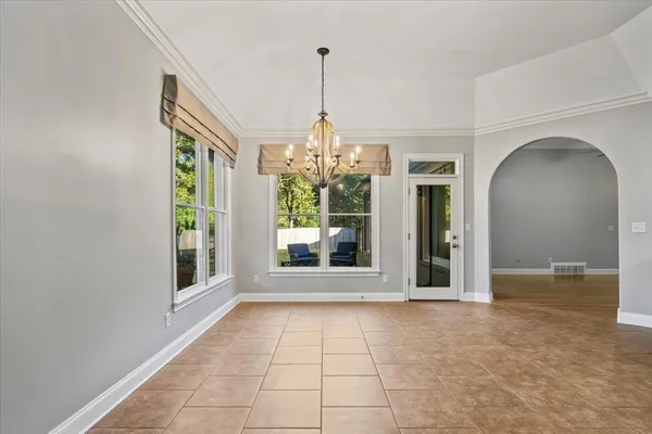 a view of a room with window and chandelier