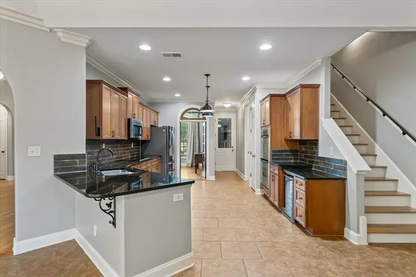 a kitchen with stainless steel appliances a stove a sink and a refrigerator