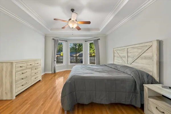 a bedroom with a large bed and a chandelier