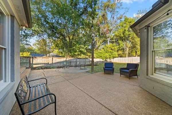 a balcony with chairs and a table