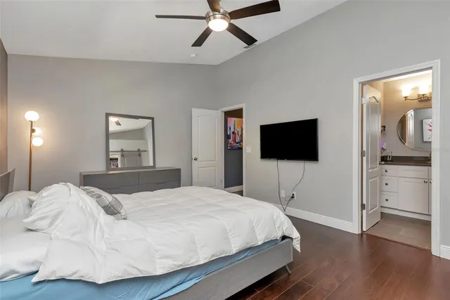 a bedroom with a bed and a painting on the wall