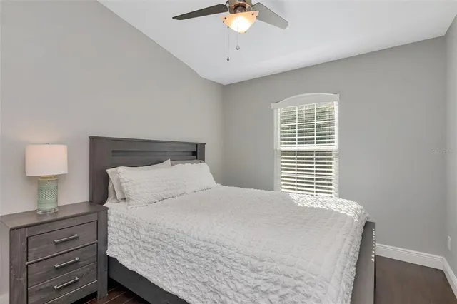 a bedroom with a bed and a night stand