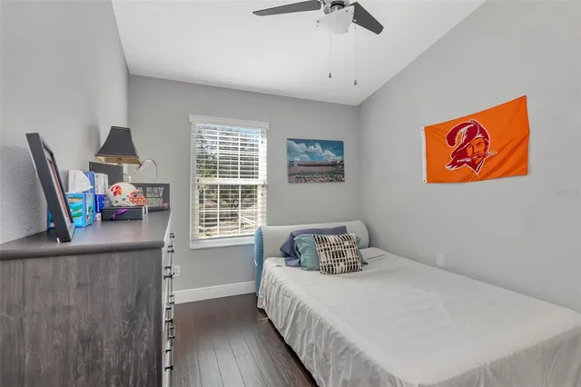 a bedroom with a bed and a painting on the wall