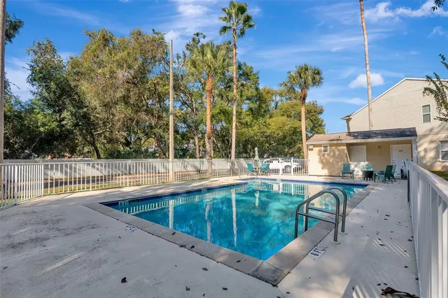 a view of backyard with deck and outdoor seating