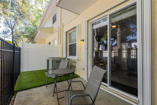a kitchen view with a sink and chairs