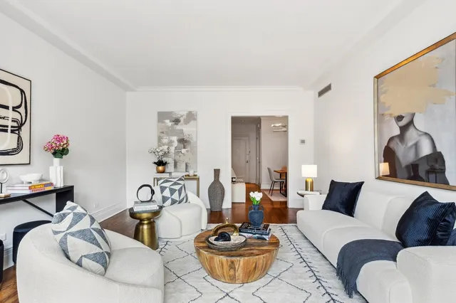 a living room with furniture a rug and a window