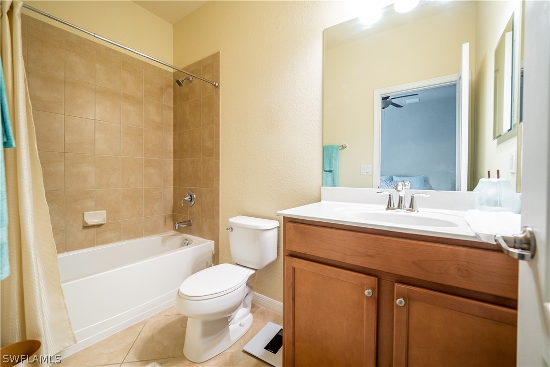 11677 Eros Road Lehigh Acres, FL 33971 - Photo 15 of 27 a bathroom with a sink a toilet and a bathtub