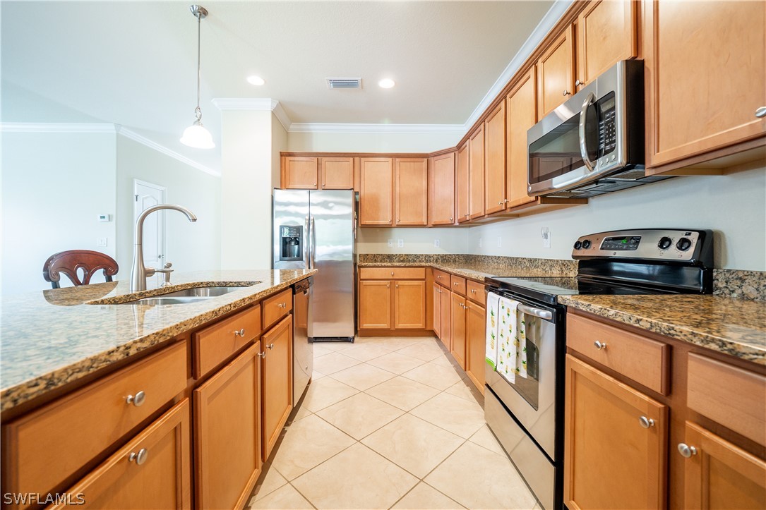 11677 Eros Road Lehigh Acres, FL 33971 - Photo 2 of 27 a kitchen with stainless steel appliances granite countertop a sink and cabinets