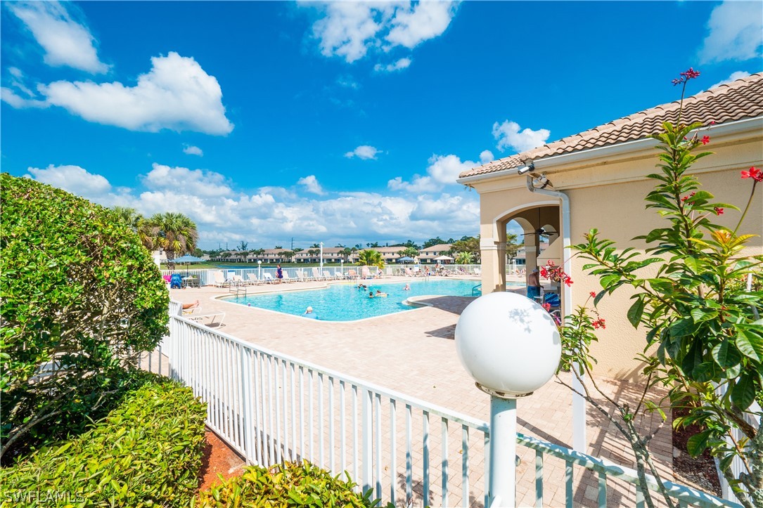 11677 Eros Road Lehigh Acres, FL 33971 - Photo 27 of 27 a view of a swimming pool with a patio and a yard