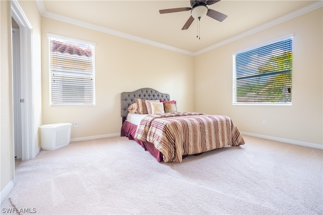 11677 Eros Road Lehigh Acres, FL 33971 - Photo 6 of 27 a bedroom with a bed and window