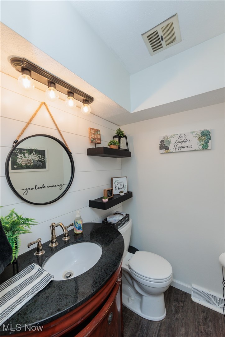 200 Granger Road, Unit 73 Medina, OH 44256 - Photo 6 of 18 Bathroom featuring vanity, wood-type flooring, and toilet