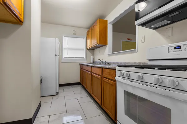 a kitchen with stainless steel appliances granite countertop a sink and a stove