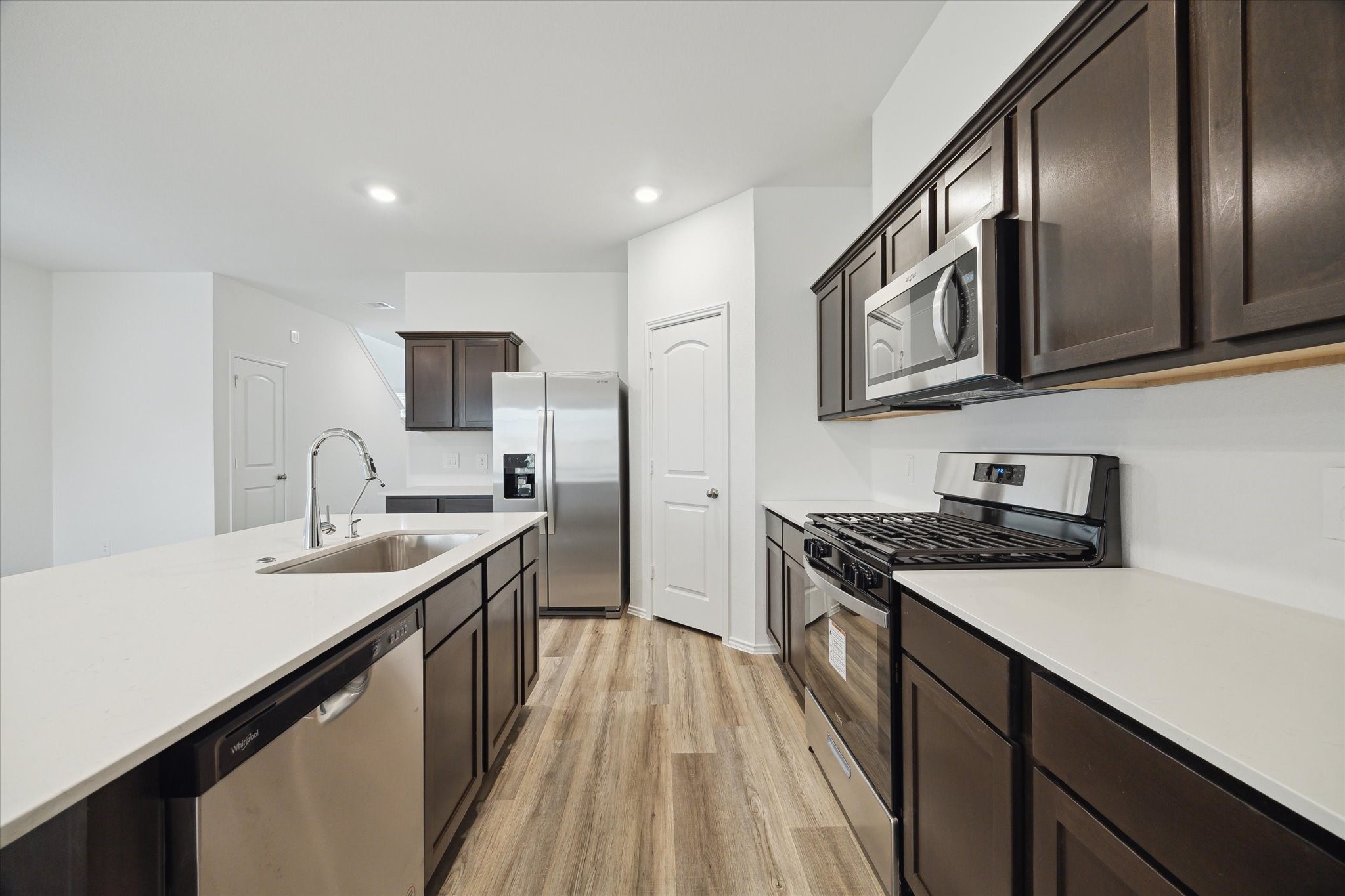 1002 Concord Pointe Lane Houston, TX 77090 - Photo 5 of 10 a kitchen with granite countertop kitchen island a sink stainless steel appliances and cabinets