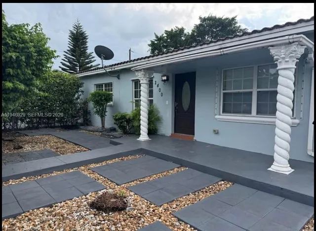 a front view of a house with garden