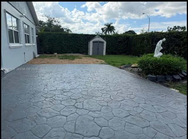 a view of a swimming pool with an outdoor space and seating area