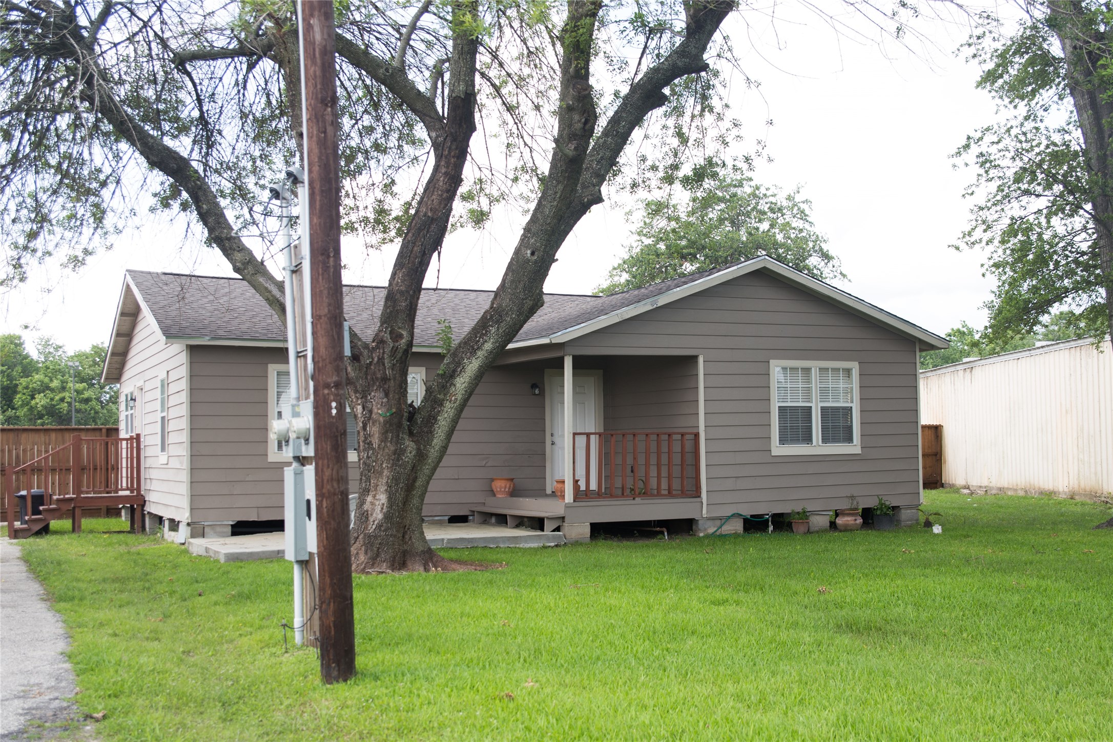 16947 Avenue A Channelview, TX 77530 - Photo 1 of 12 a view of backyard with plants and large tree