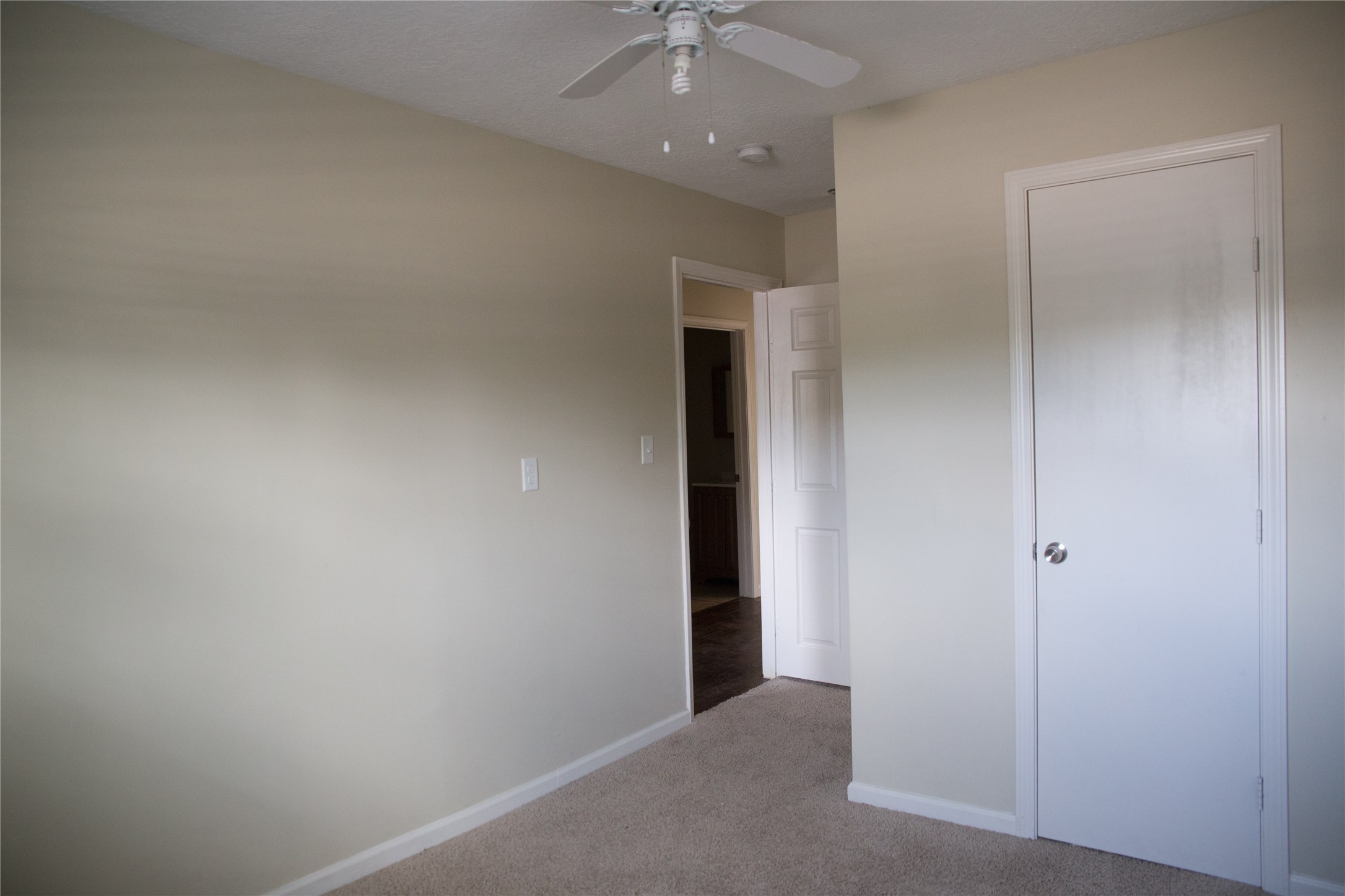 16947 Avenue A Channelview, TX 77530 - Photo 12 of 12 an empty room with a hallway and a chandelier fan