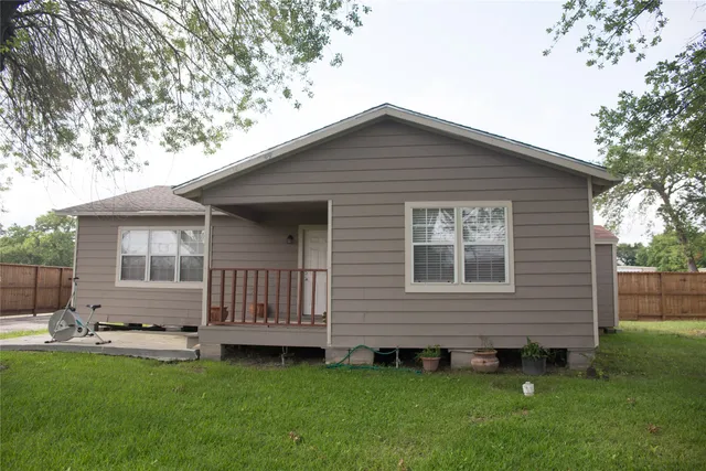 a backyard of a house with table and chairs