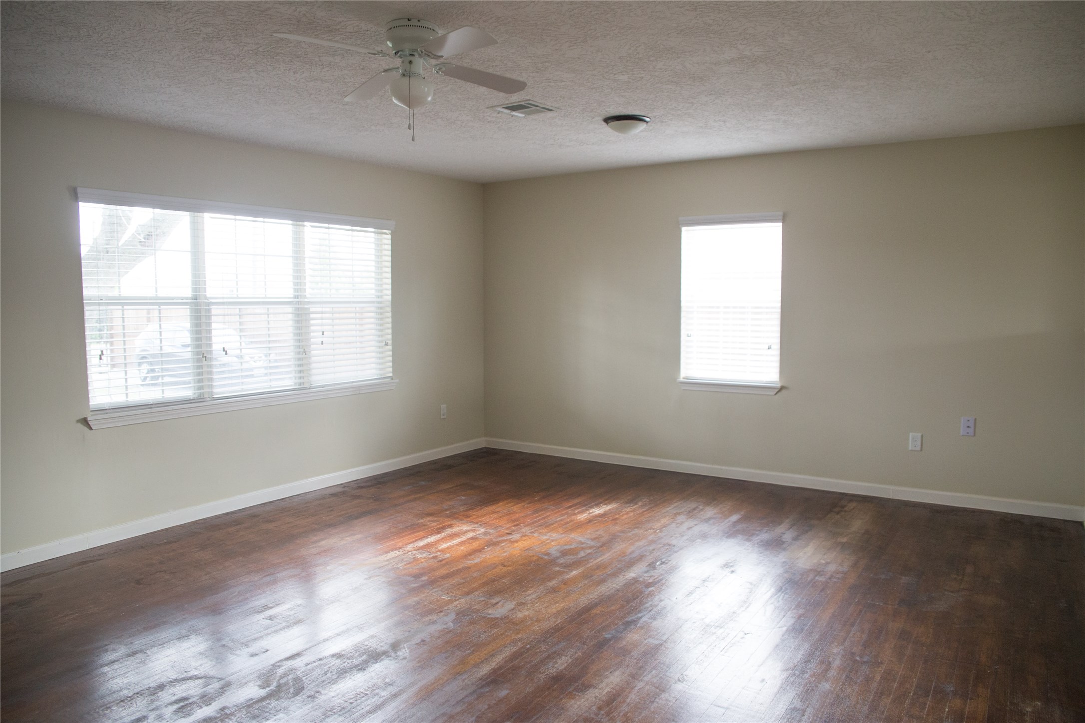 16947 Avenue A Channelview, TX 77530 - Photo 4 of 12 a view of an empty room with wooden floor and a window