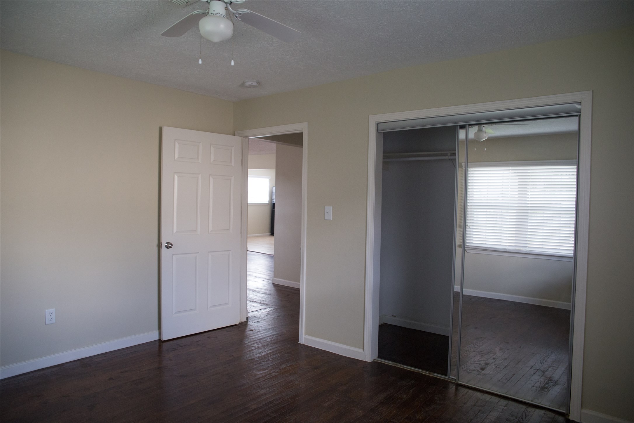 16947 Avenue A Channelview, TX 77530 - Photo 8 of 12 an empty room with wooden floor closet and windows