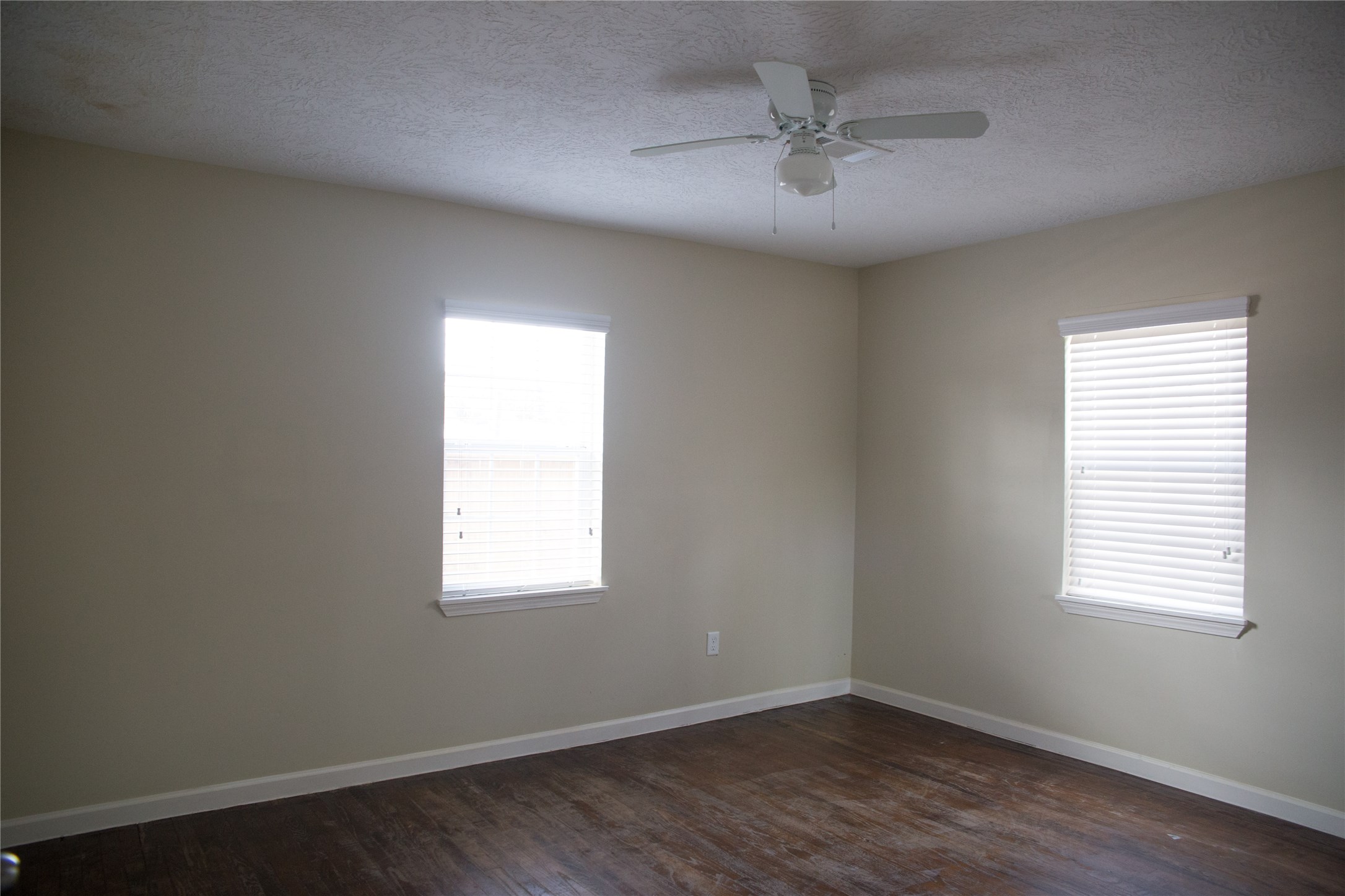 16947 Avenue A Channelview, TX 77530 - Photo 9 of 12 wooden floor in an empty room with a window