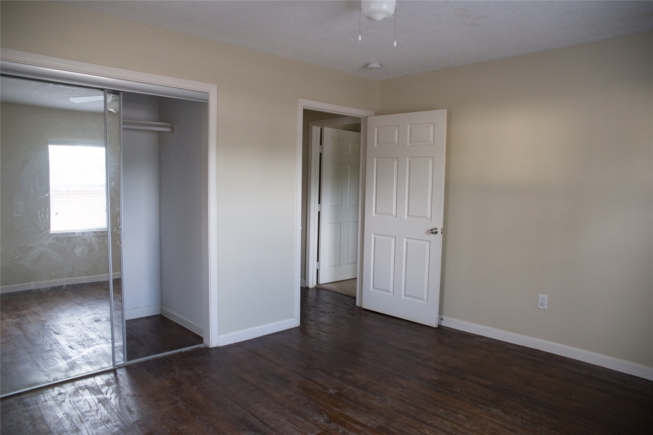 16947 Avenue A Channelview, TX 77530 - Photo 10 of 12 an empty room with wooden floor & windows