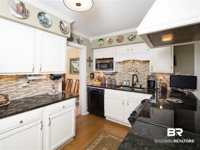 640 Spanish Main Spanish Fort, AL 36527 - Photo 11 of 33 Upgraded kitchen with newer appliances, granite counter tops, tile backsplash, under mount lighting.