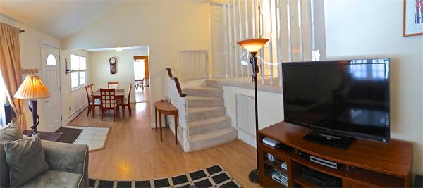 7 Lexington Road Billerica, MA 01821 - Photo 9 of 20 a living room with furniture a flat screen tv and floor to ceiling windows