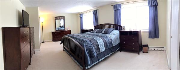 7 Lexington Road Billerica, MA 01821 - Photo 10 of 20 a bedroom with a bed closet and flat tv screen
