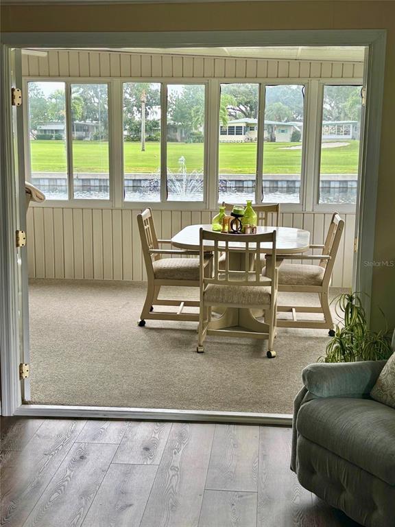 1100 South Belcher Road, Unit 454 Largo, FL 33771 - Photo 13 of 61 a view of a living room with furniture and floor to ceiling windows