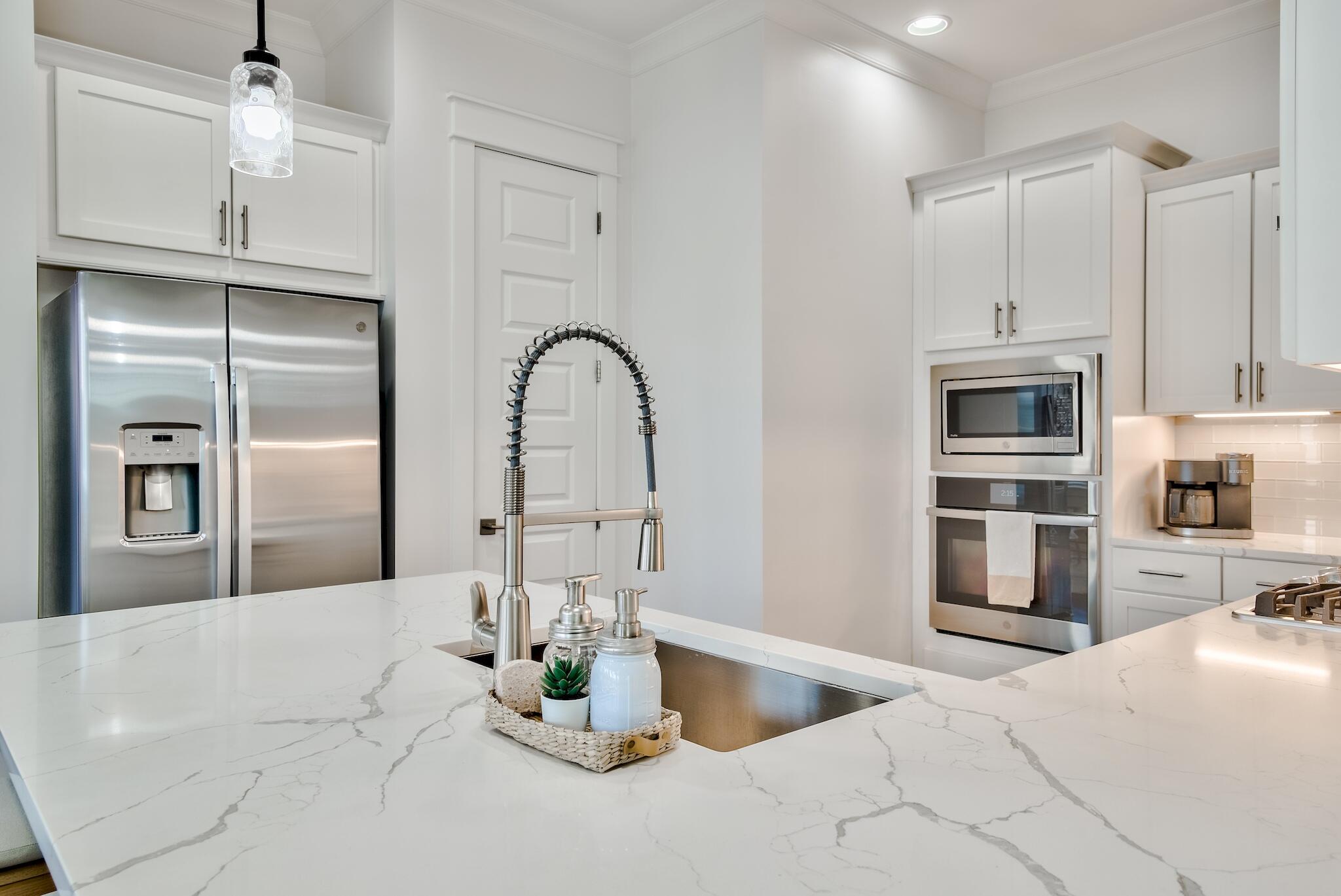 60 Milestone Dr Inlet Beach, Unit C Inlet Beach, FL 32461 - Photo 8 of 21 a kitchen with stainless steel appliances kitchen island granite countertop a refrigerator a sink a stove and oven