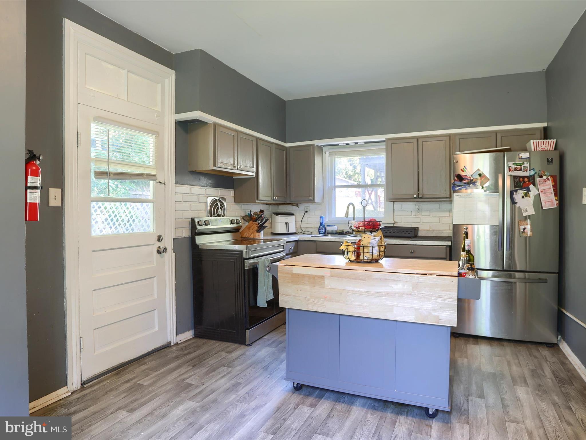 241 Pine Street Steelton, PA 17113 - Photo 12 of 32 a kitchen with stainless steel appliances granite countertop a stove a refrigerator and a refrigerator