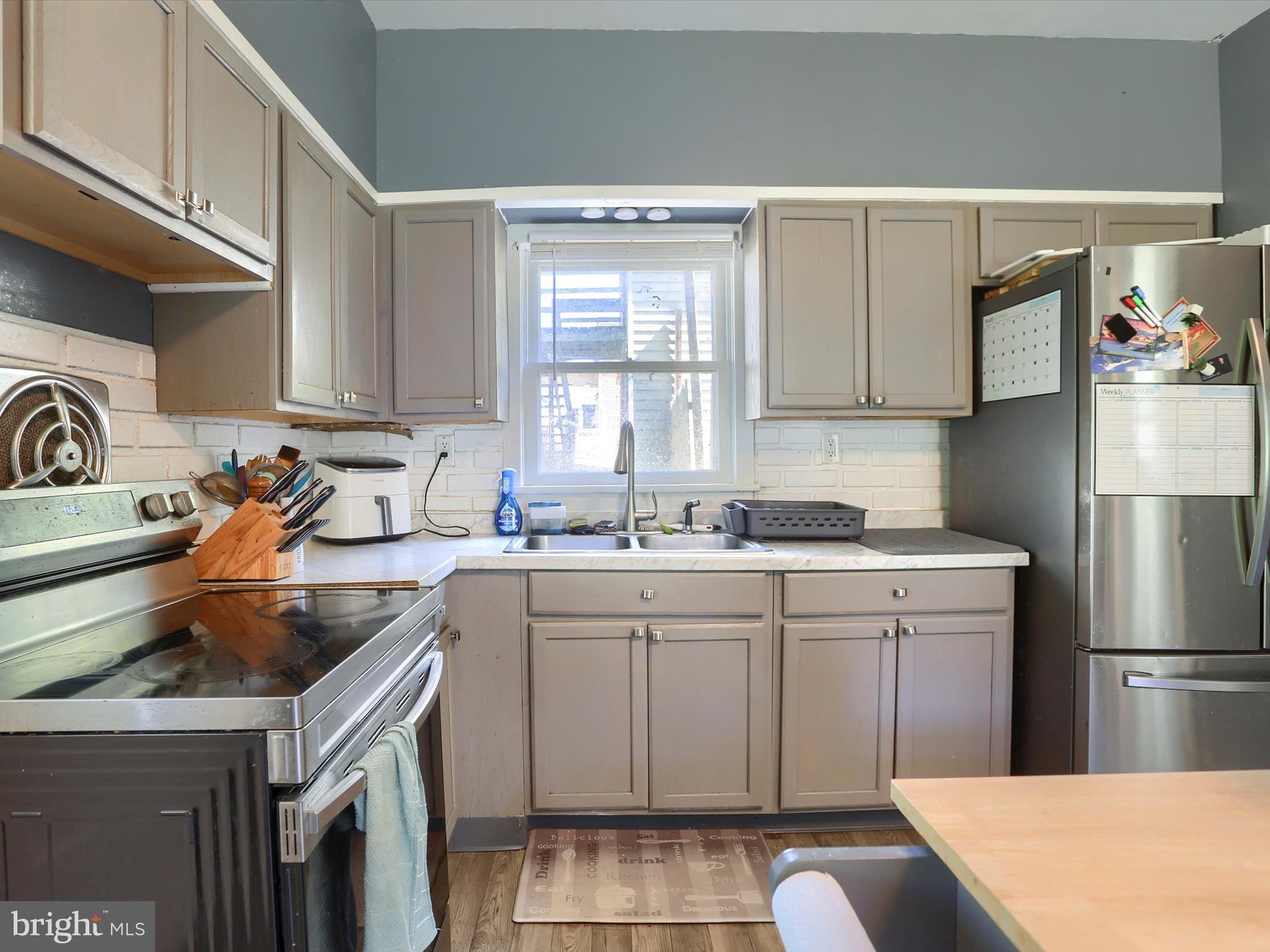 241 Pine Street Steelton, PA 17113 - Photo 13 of 32 a kitchen with a sink a stove a refrigerator and cabinets