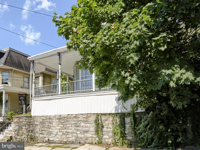 front view of a house with a tree