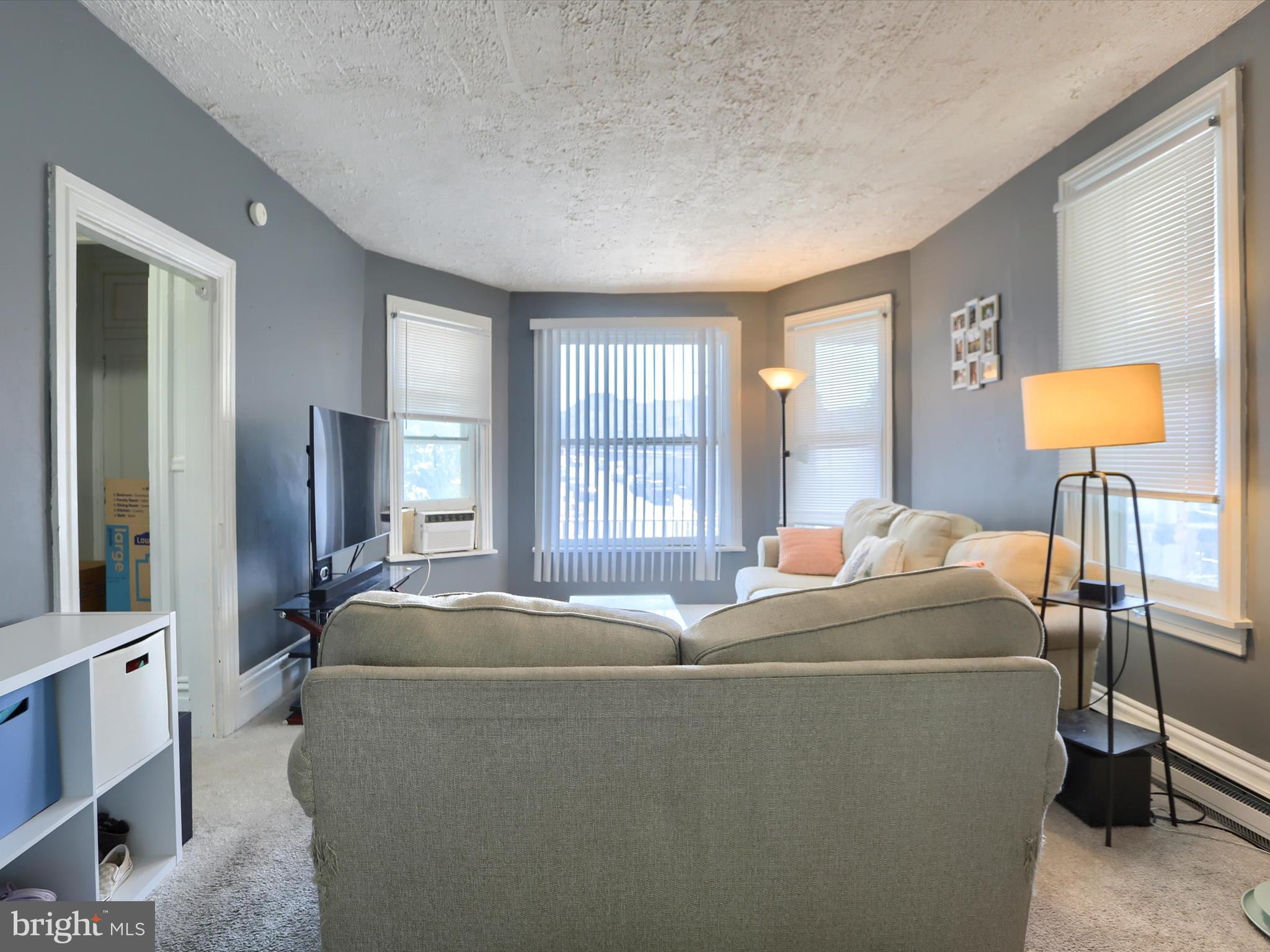 241 Pine Street Steelton, PA 17113 - Photo 4 of 32 a room with a bed and a lamp on table