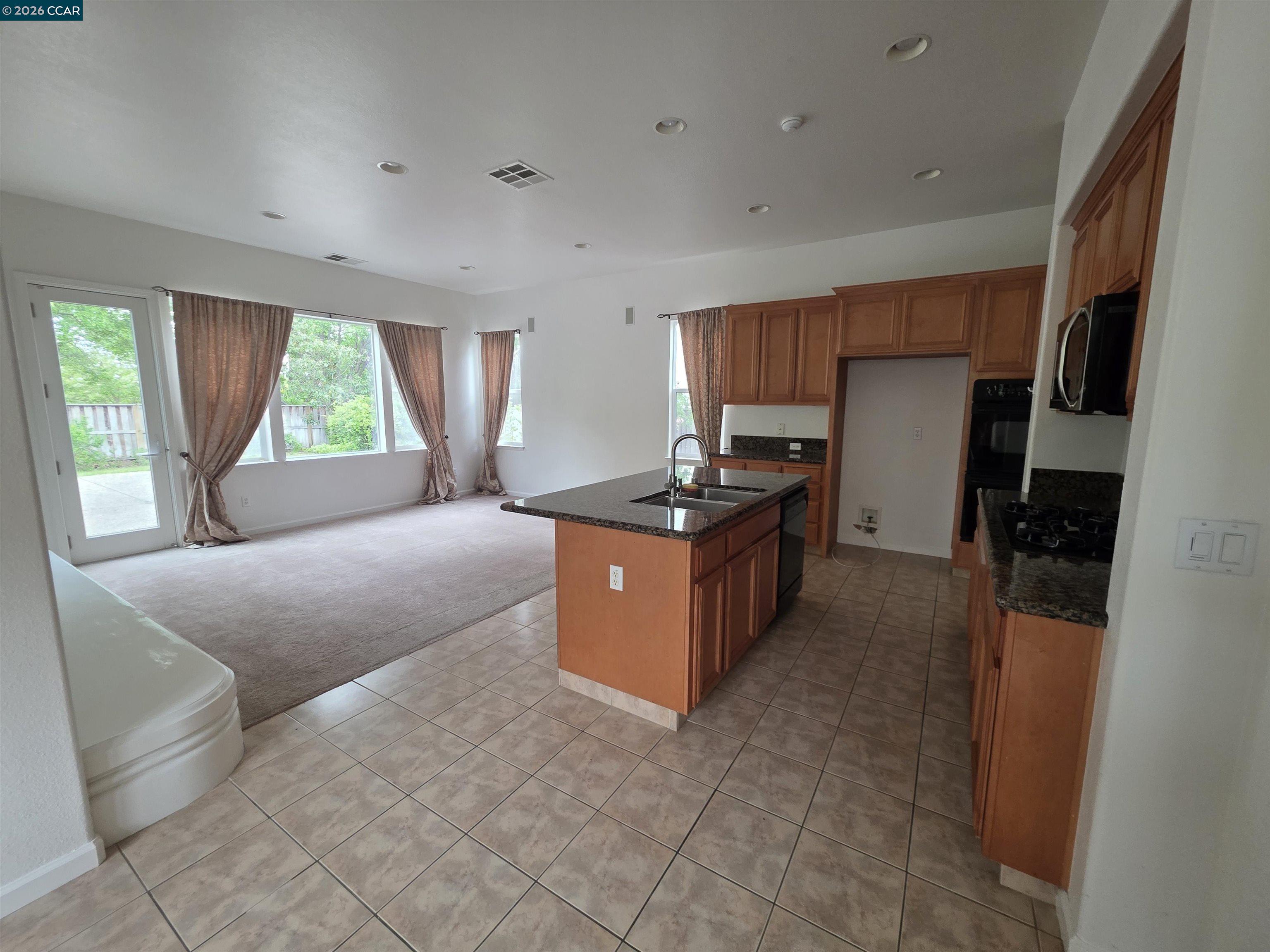 1830 Hollyview Drive San Ramon, CA 94582 - Photo 11 of 36 a kitchen with stainless steel appliances granite countertop a stove a refrigerator and a sink