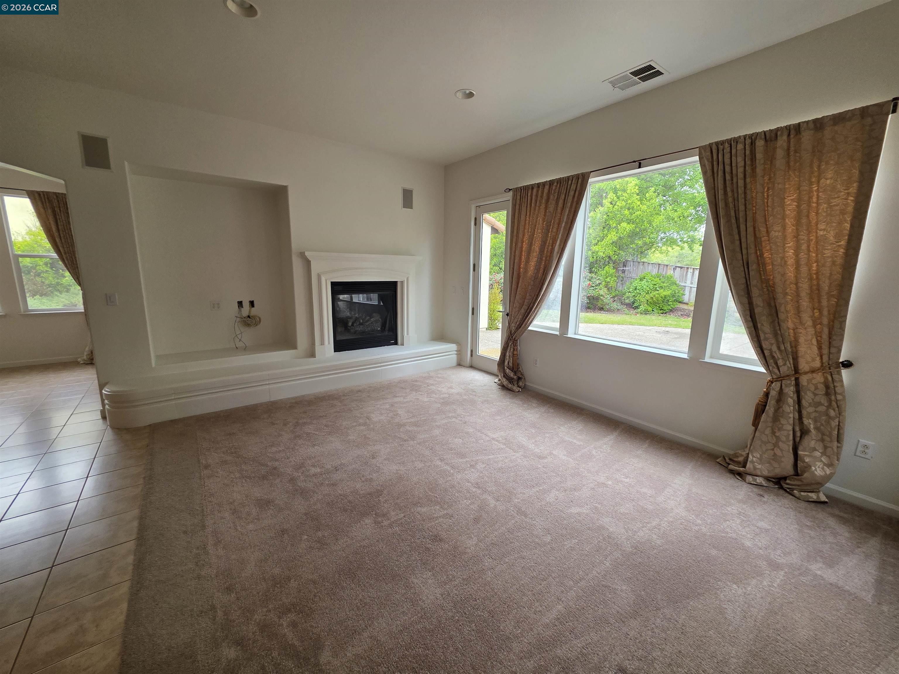 1830 Hollyview Drive San Ramon, CA 94582 - Photo 12 of 36 a view of an empty room with a fireplace and a window