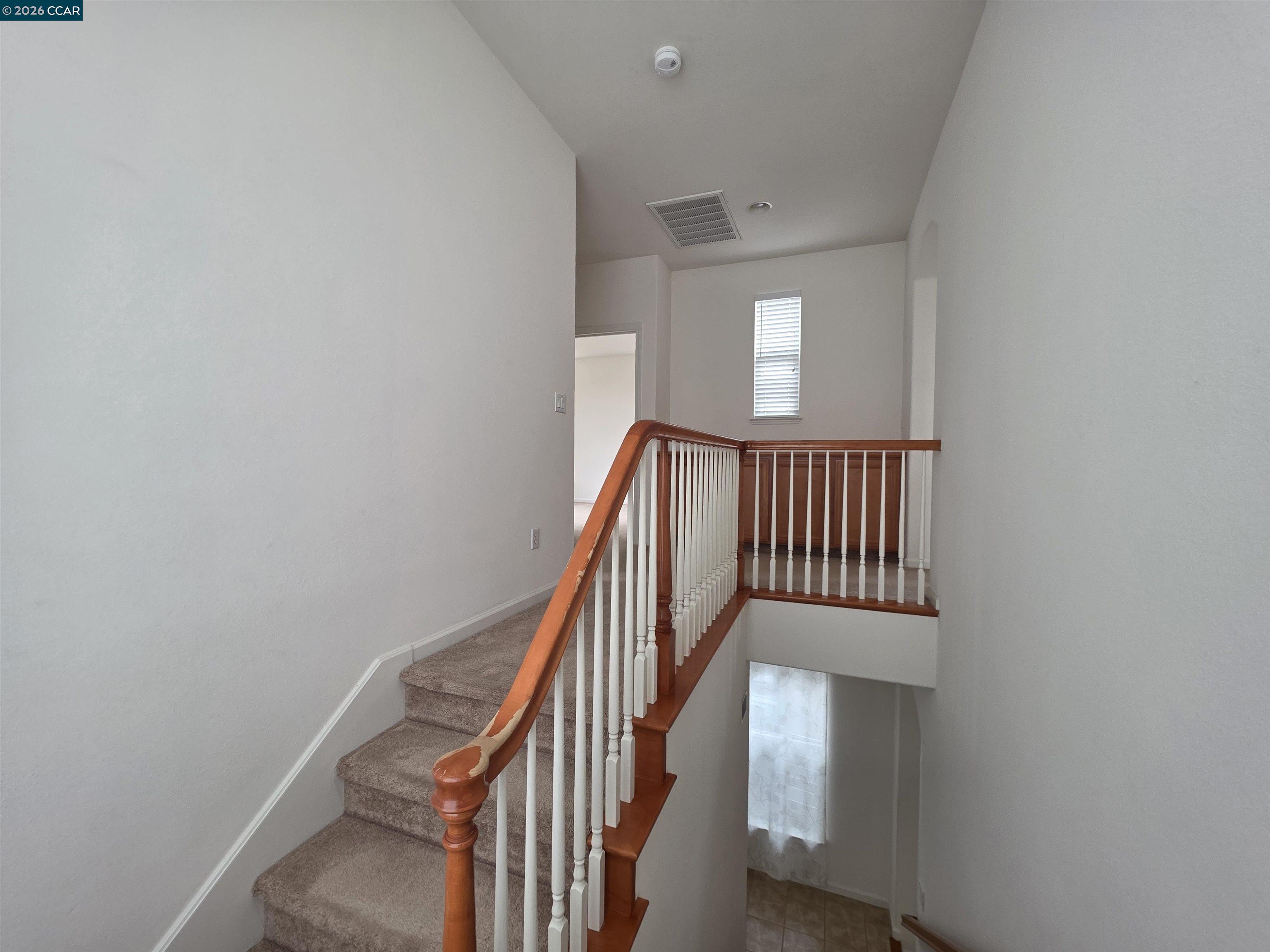 1830 Hollyview Drive San Ramon, CA 94582 - Photo 16 of 36 a view of staircase with wooden floor and white walls