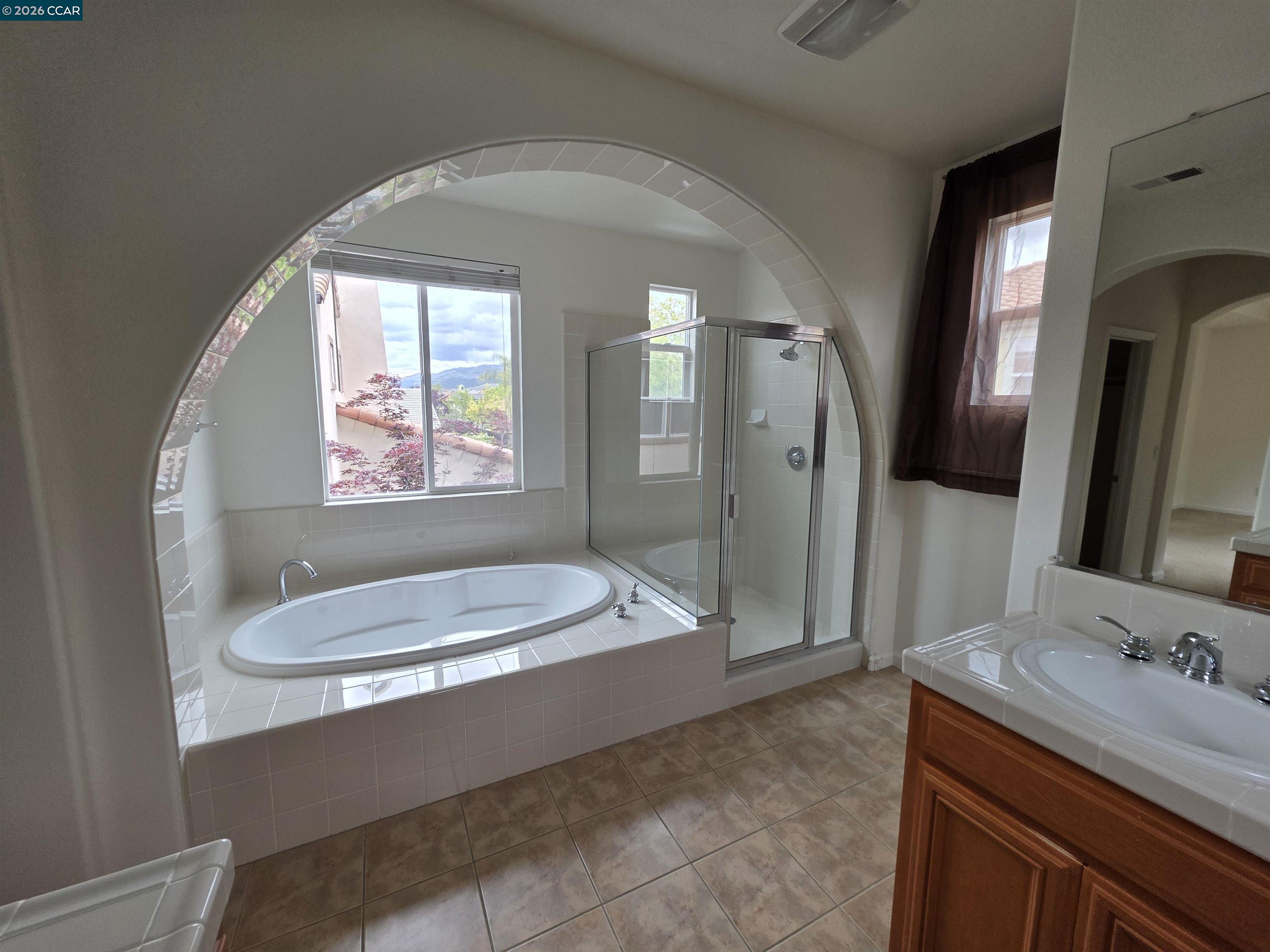 1830 Hollyview Drive San Ramon, CA 94582 - Photo 22 of 36 a bathroom with a granite countertop sink and a mirror