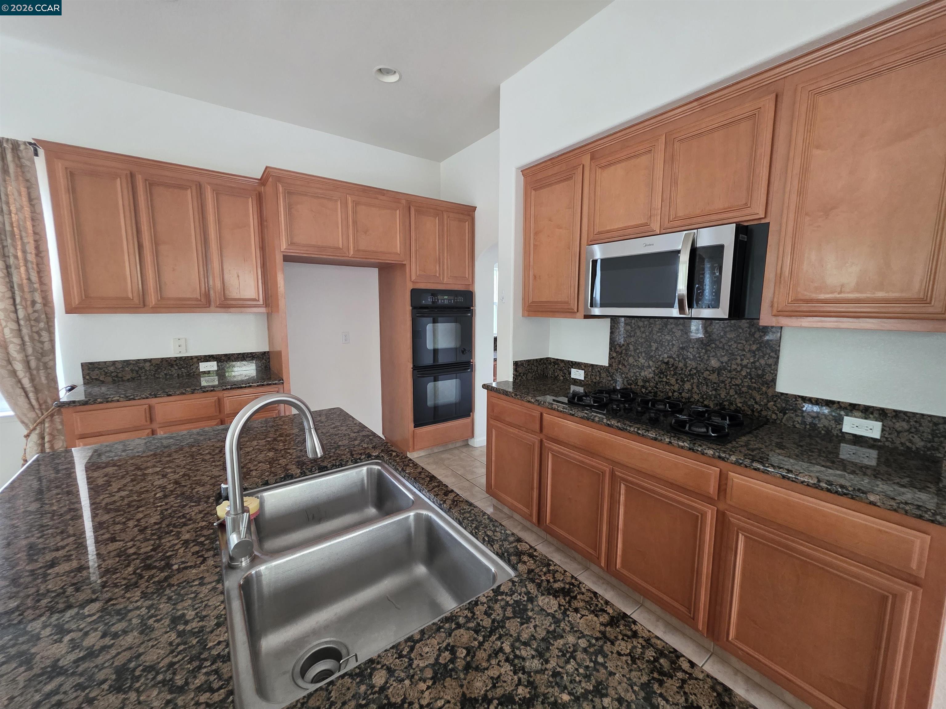 1830 Hollyview Drive San Ramon, CA 94582 - Photo 9 of 36 a kitchen with stainless steel appliances granite countertop a stove a sink dishwasher a microwave oven with granite countertops and cabinets