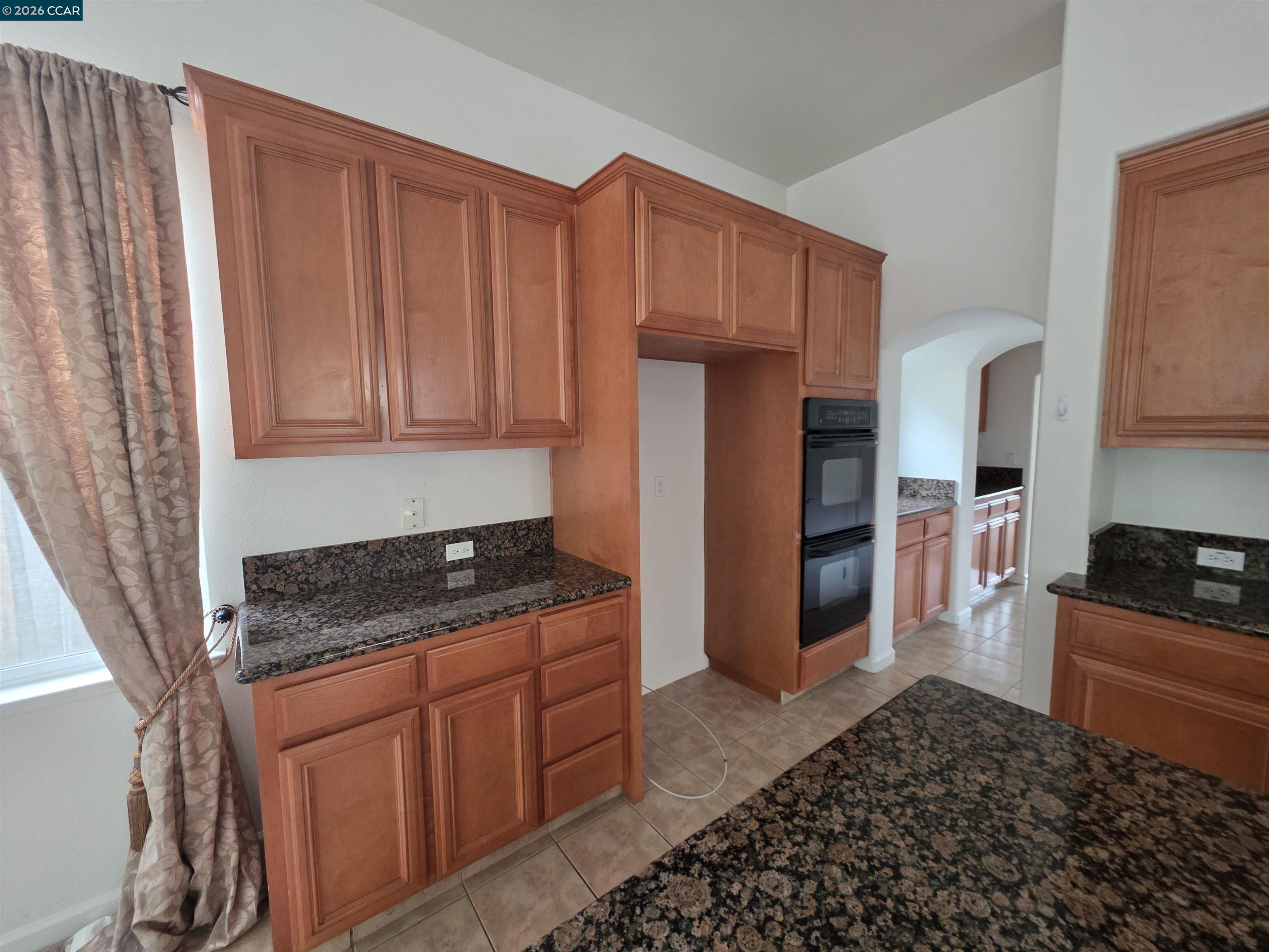 1830 Hollyview Drive San Ramon, CA 94582 - Photo 10 of 36 a kitchen with stainless steel appliances granite countertop a refrigerator and a stove