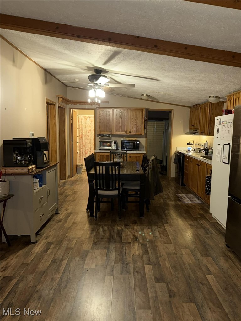 56 3rd Street Rayland, OH 43943 - Photo 39 of 46 Dining room with dark wood-style floors, ceiling fan, lofted ceiling, and a textured ceiling