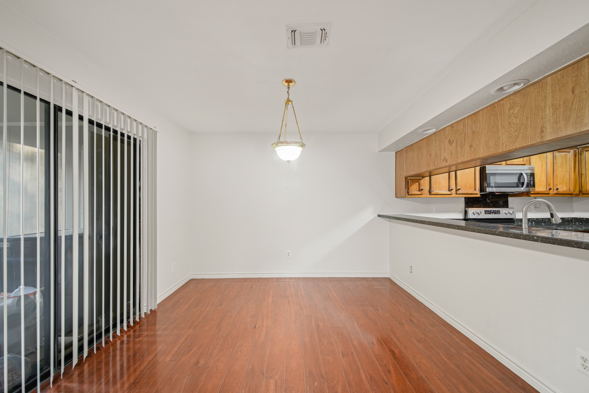 8100 Cambridge Street, Unit 6 Houston, TX 77054 - Photo 11 of 23 a view of a kitchen with a sink wooden floor and a window