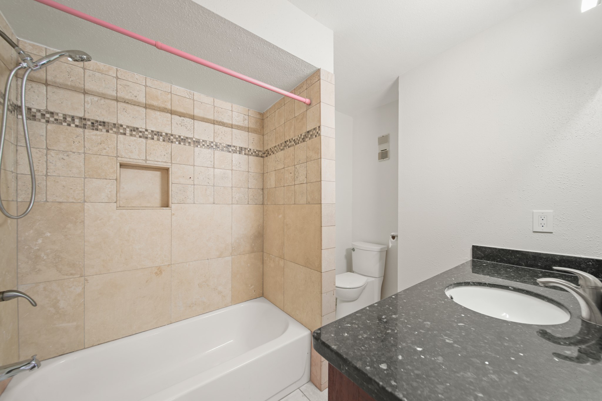 8100 Cambridge Street, Unit 6 Houston, TX 77054 - Photo 21 of 23 a bathroom with a granite countertop sink a toilet and shower