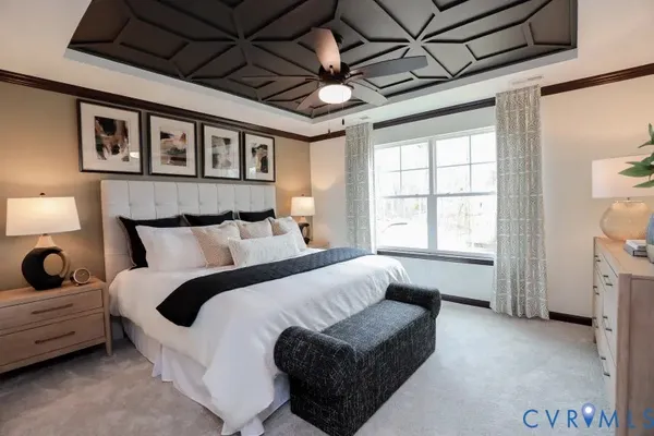 a spacious bedroom with a bed a couch and a window