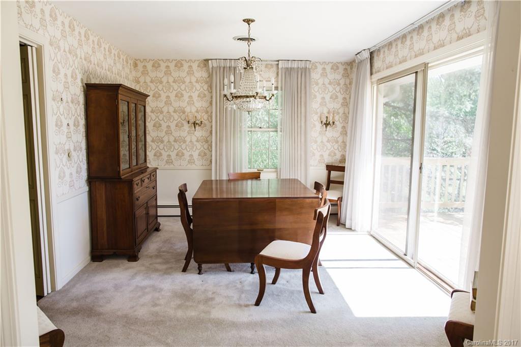 206 Brandon Road Hendersonville, NC 28739 - Photo 8 of 16 a living room with furniture a large window and a refrigerator