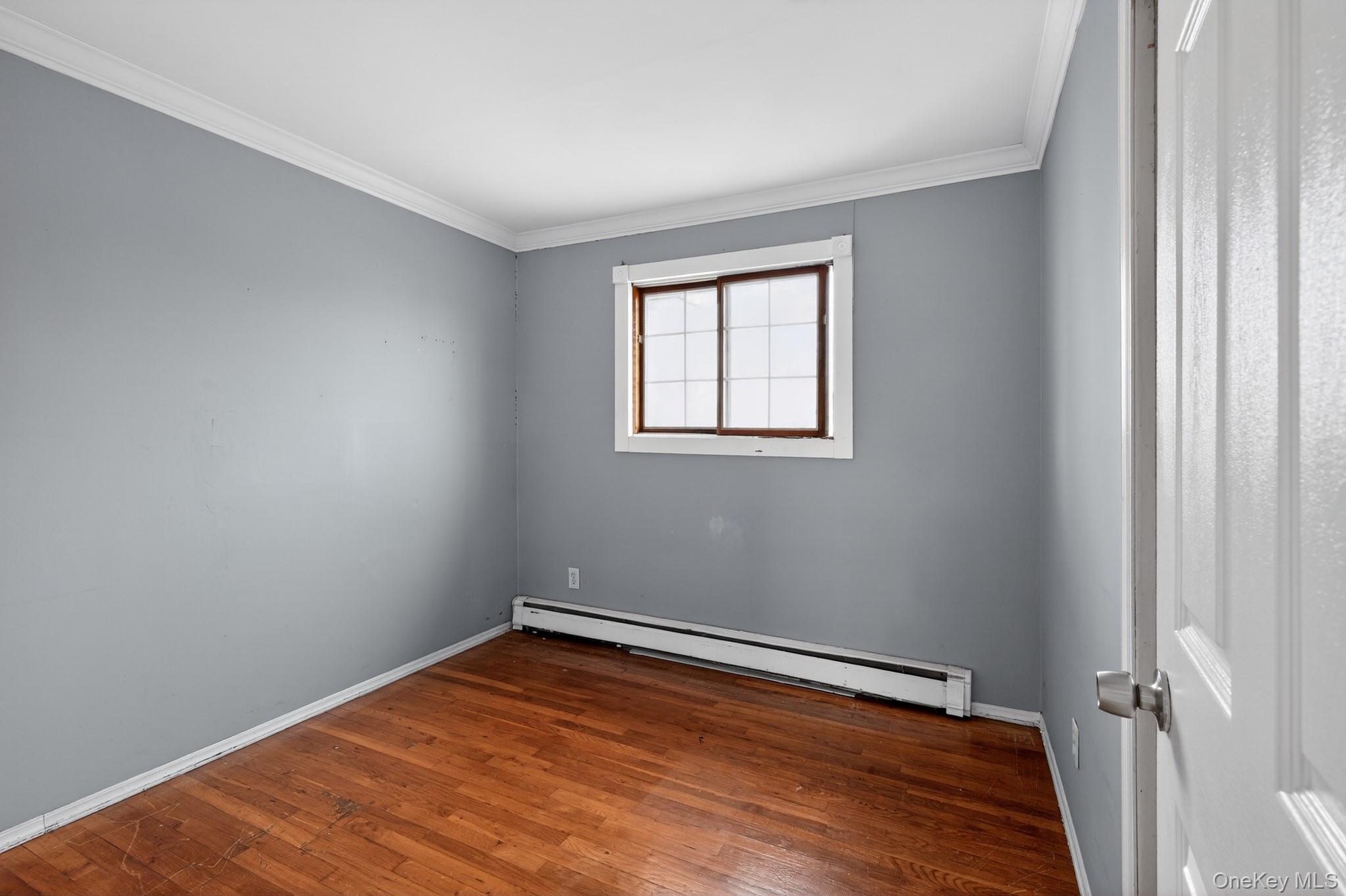 138 Spring Street Massapequa, NY 11758 - Photo 19 of 45 a view of a room with wooden floor and a window