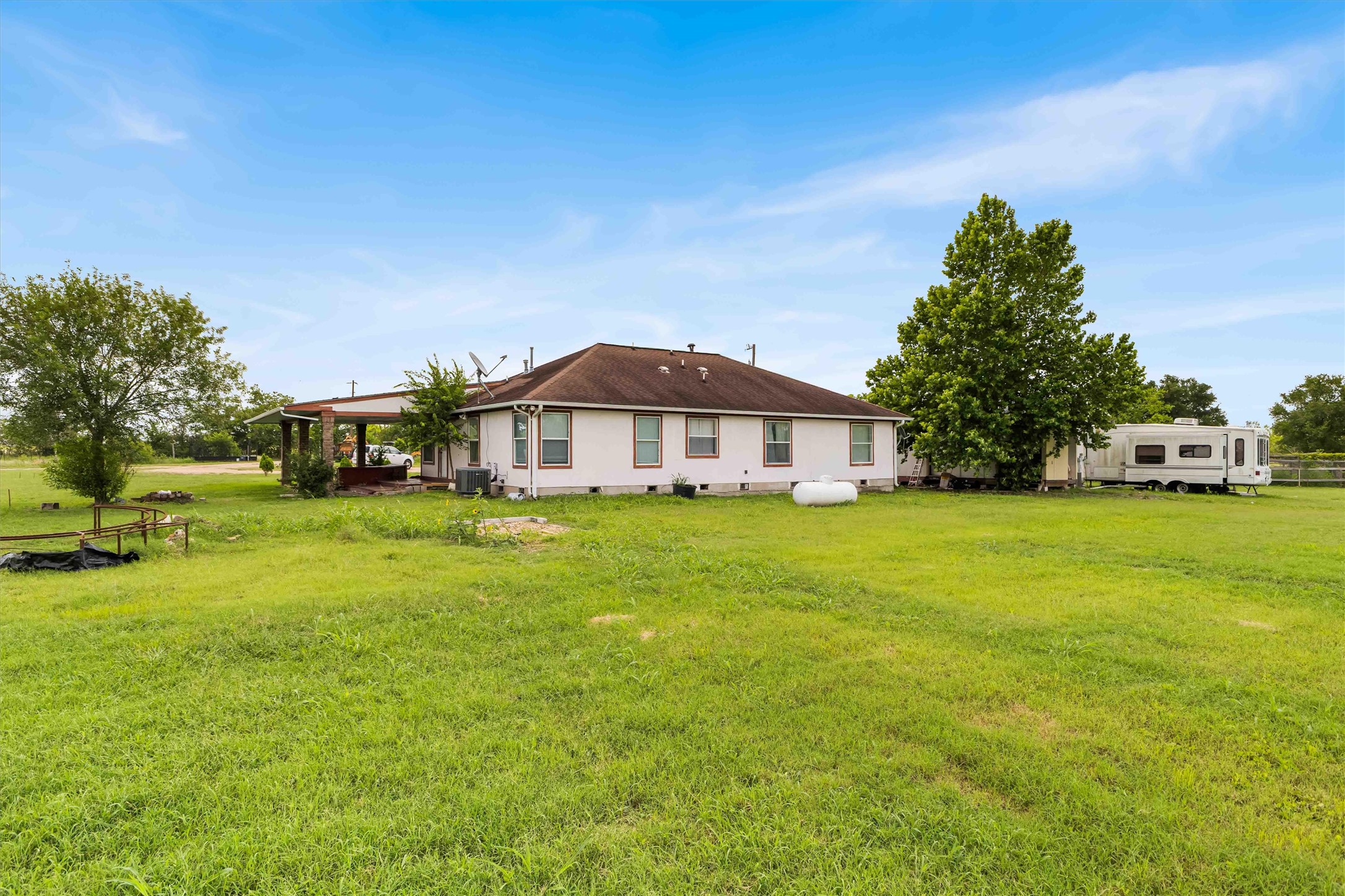 12212 Ballerstedt Road Elgin, TX 78621 - Photo 30 of 39 Rear view of property with crawl space and a lawn