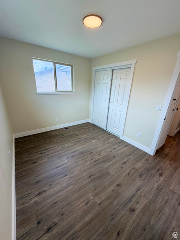 450 13800 South, Unit 2 Draper, UT 84020 - Photo 9 of 21 Room featuring wood-finish flooring, a double-door closet, a single window, and a flush mount ceiling light fixture